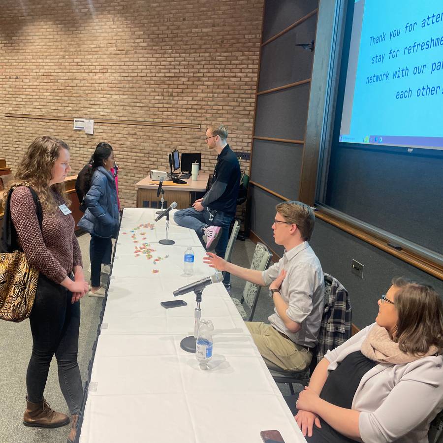 students talking to alumni at a panel